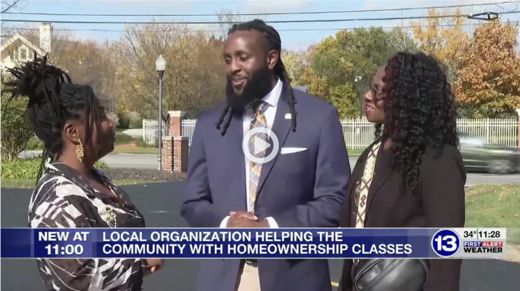Rob Pasker speaks with community members during a 13ABC news segment highlighting free homeownership education classes in Toledo.